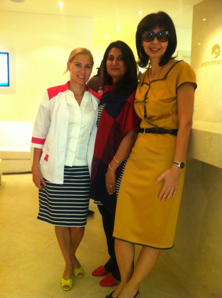 Three women, including an American-trained female LASER therapist from Boston Aesthetics Lahore, stand together at the Institute of Medical Aesthetics in Dubai, UAE, demonstrating their expertise in safe and effective LASER hair removal for achieving smooth, hair-free skin.