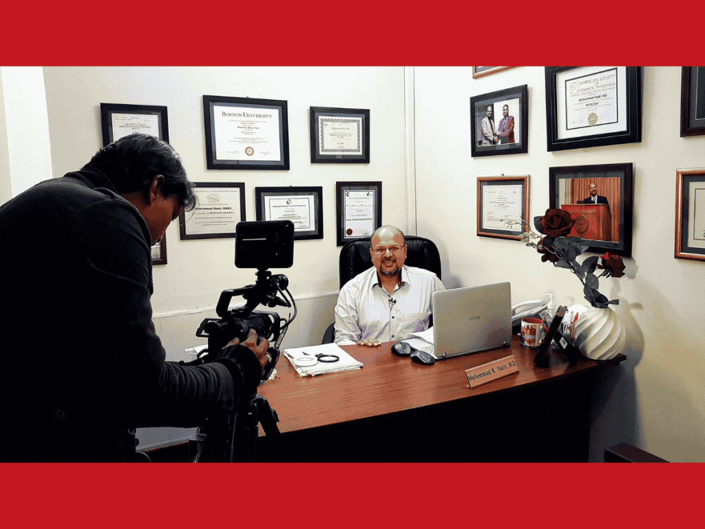 Dr. M. Khawar Nazir, a distinguished dermatologist, being filmed for a health awareness TV program, discussing dermatology issues in his office surrounded by his certifications and accolades.
