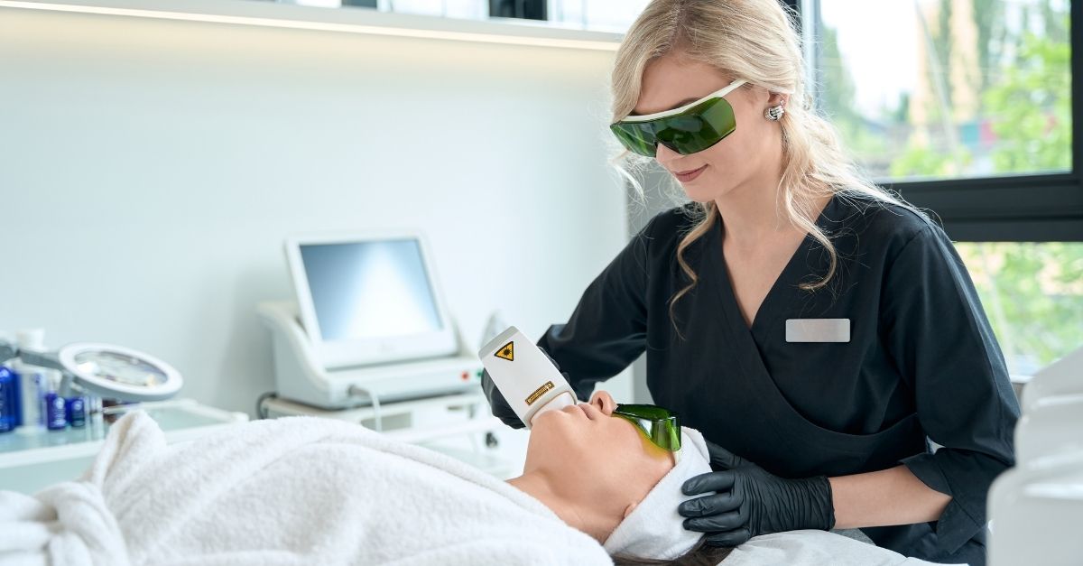 A certified laser therapist performing facial laser hair removal on a female patient for smooth and permanent hair reduction in Lahore clinic