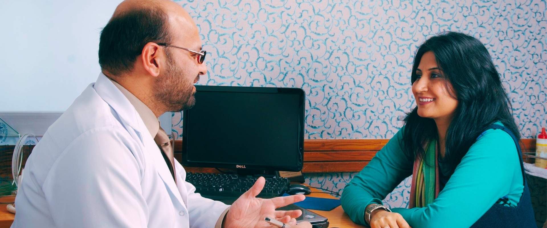Dermatologist in Lahore consulting with a patient.